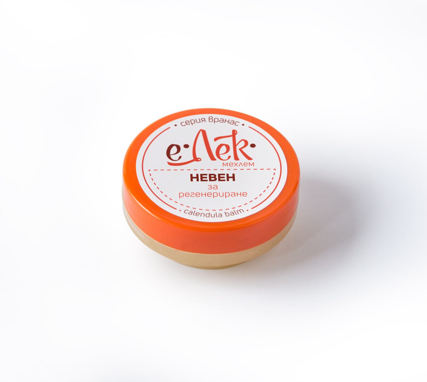 A small open container of 'E-ek' brand calendula ointment with a label that includes the product name and information in Russian. The container is filled with a solid pale yellow substance.